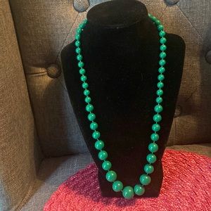 Graduated green plastic necklace